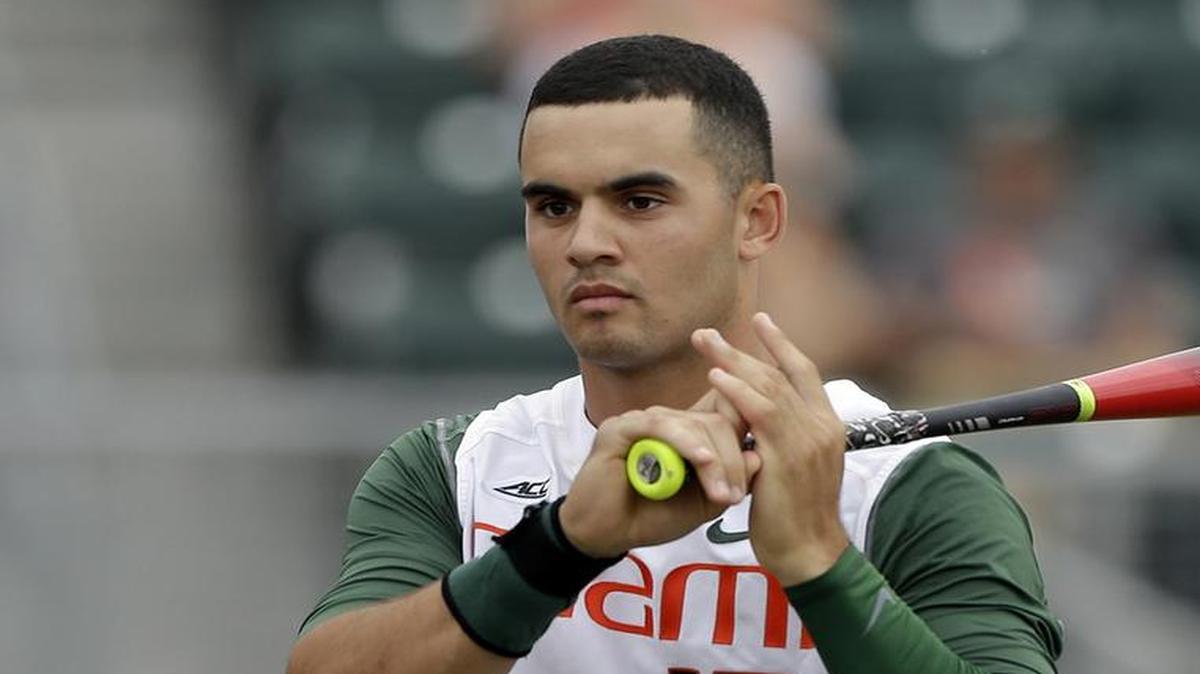
Miami's Willie Abreu (13) warms up during the super regionals of the NCAA college baseball tournament against VCU, Friday, June 5, 2015, in Coral Gables, Fla. 
