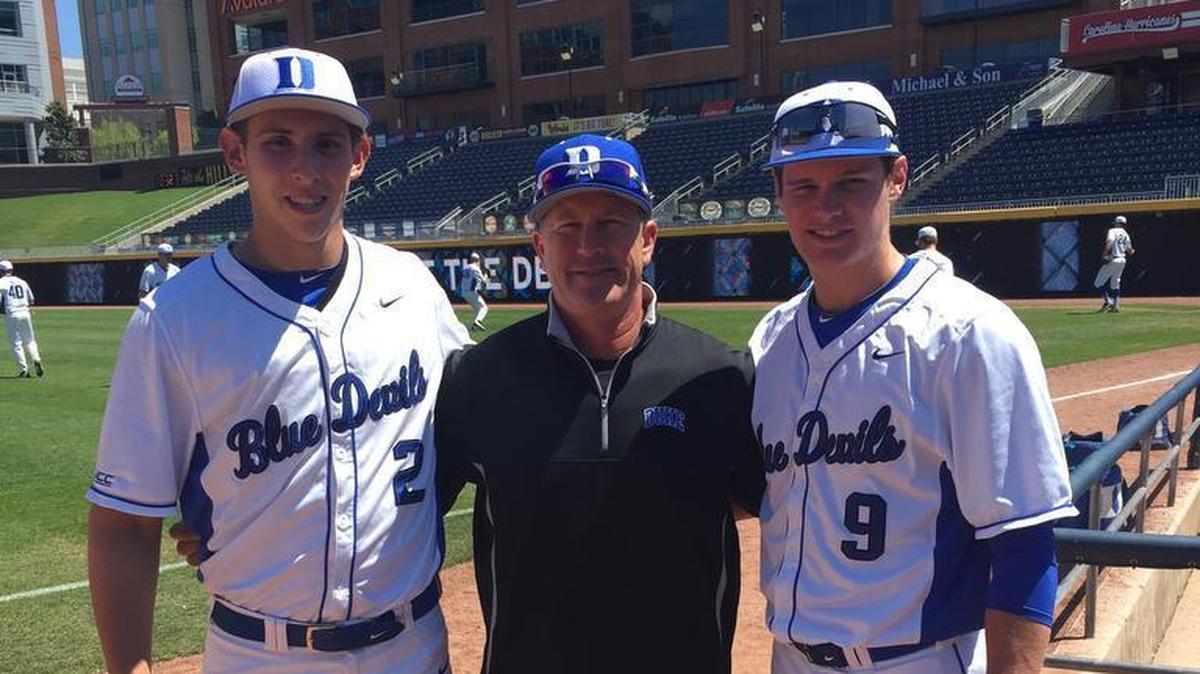 Coach Wayne Stofsky, center, with junior Zack Kone and Griffin Conine, right.