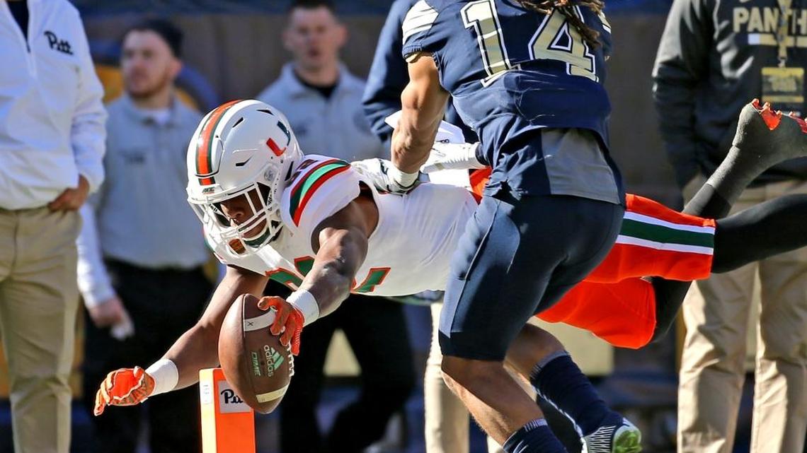 Miami Hurricanes Ahmmon Richards (82) dives for a second quarter touchdown as Pitt Panthers Avonte Maddox (14) fails to defend at Heinz Field in Pittsburgh, Pa, November 24, 2017.