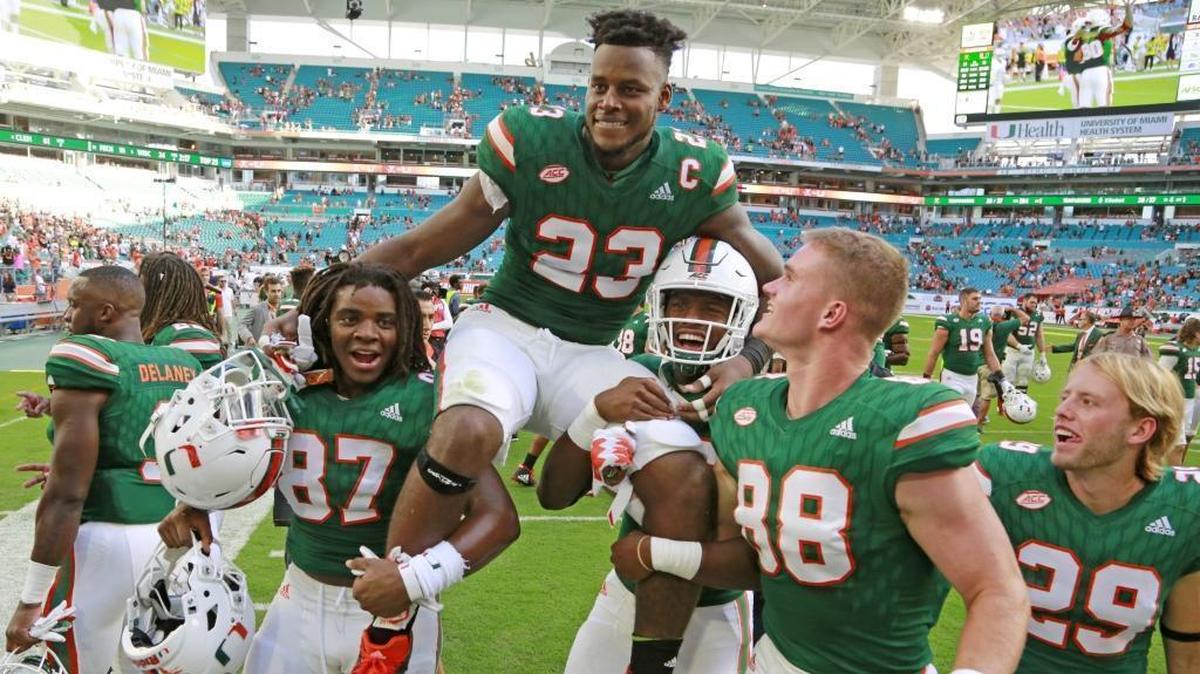 Miami Hurricanes senior tight end Christopher Herndon is carried off by teammates after Miami defeated the Virginia Cavaliers at Hard Rock Stadium on Saturday, November 18, 2017.