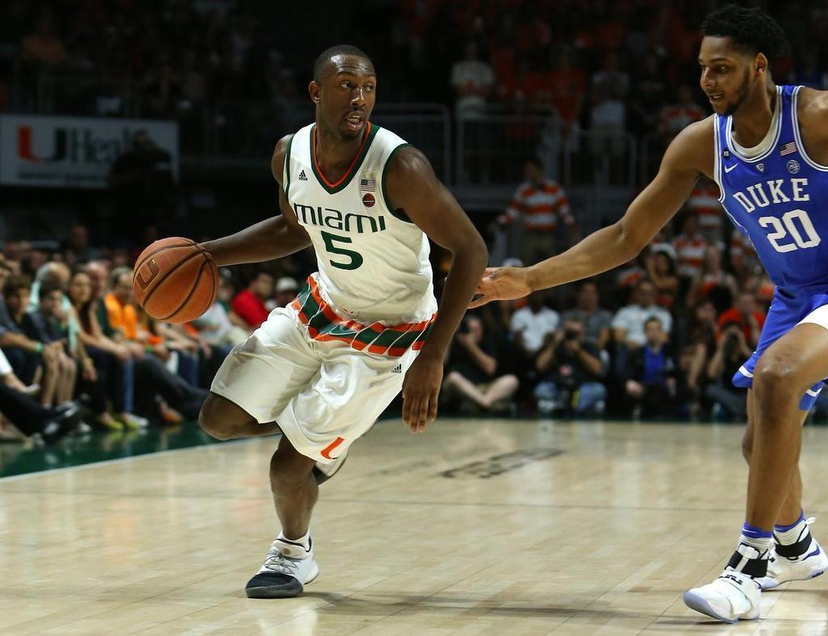 Miami Hurricanes guard Davon Reed drives against Duke Blue Devils center Marques Bolden during a game in February 2017. Reed is now trying to earn a two-way contract from the Heat.