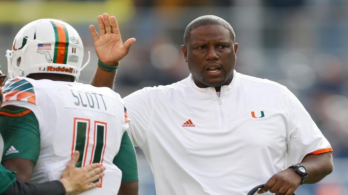 Miami head coach Larry Scott gets Miami wide receiver Rashawn Scott (11) after the team scored a touchdown in the first quarter of an NCAA college football game against Pittsburgh, Friday, Nov. 27, 2015, in Pittsburgh. Miami won 29-24.