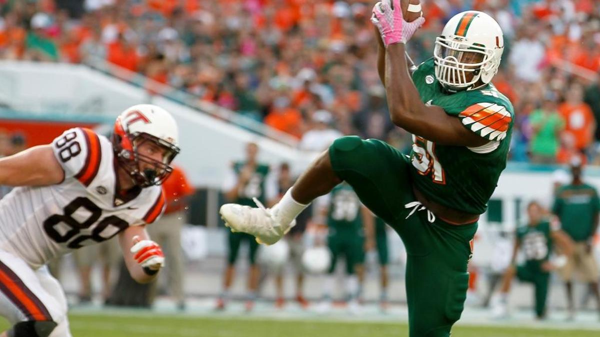 UM linebacker Juwon Young makes a key interception in the third quarter of a win over Virginia Tech on Saturday, Oct. 17, 2015 at Sun Life Stadium in Miami.