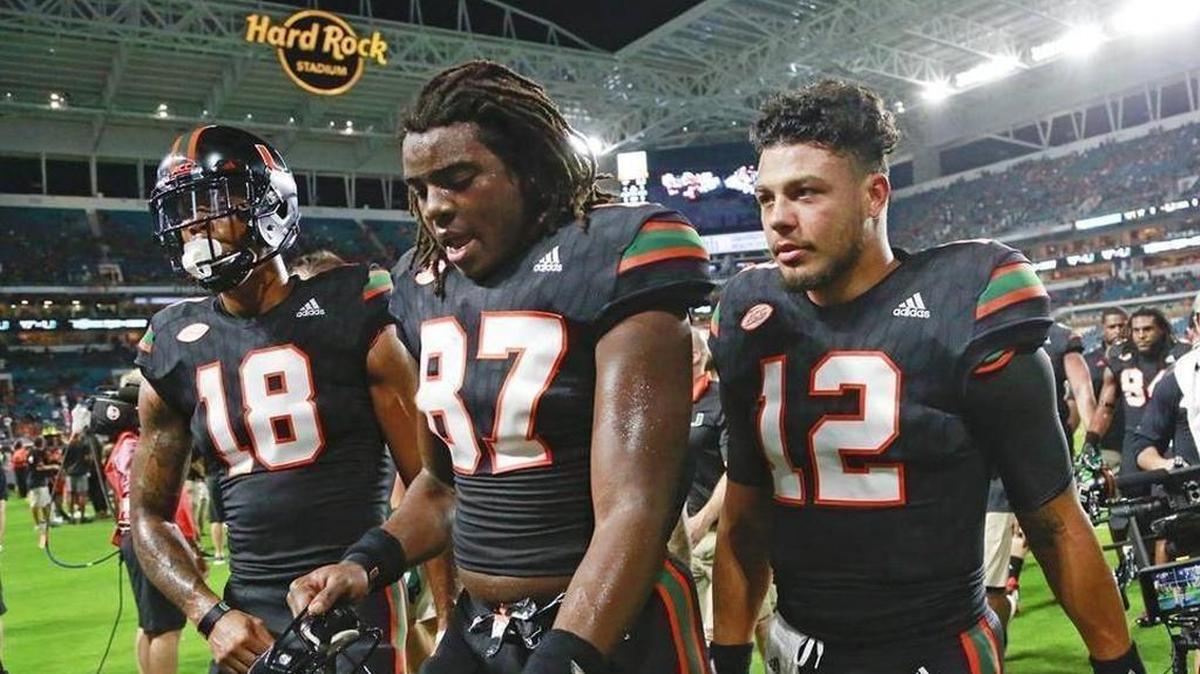 Lawrence Cager (18), Michael Irvin II (87) and quarterback Malik Rosier walk off the field after Miami’s victory over Virginia Tech on Saturday, Nov. 4, 2017