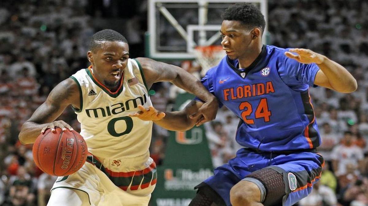 UM guard Ja’Quan Newton (0) drives against Florida Gators forward Justin Leon (24) at BankUnited Center in Coral Gables on Tuesday, Dec. 8, 2015.