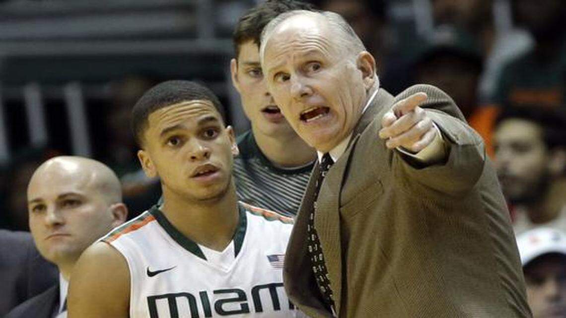 
Miami head coach Jim Larranaga, right, talks with guard Manu Lecomte (20) in the second half of an NCAA college basketball game, against South Alabama, Friday, Nov. 28, 2014, in Coral Gables, Fla. Miami defeated South Alabama 87-75. 
