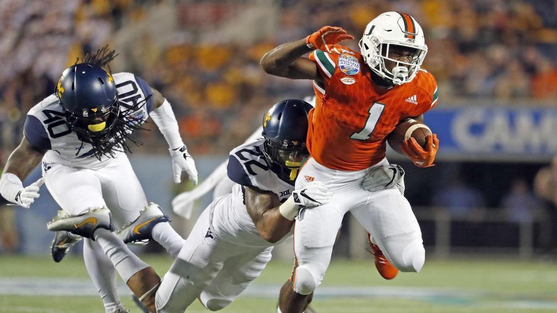 Miami Hurricanes running back Mark Walton shown rushing for a a first down the West Virginia Mountaineers at the Russell Athletic Bowl in Orlando on Dec. 28, 2016. Walton is now preparing for Toledo on Saturday.