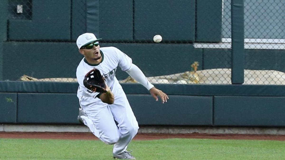 Miami right fielder Willie Abreu catches a fly ball hit by Arizona's Cesar Salazar duirng the fourth inning of an NCAA College World Series baseball game in Omaha, Neb., Saturday, June 18, 2016.