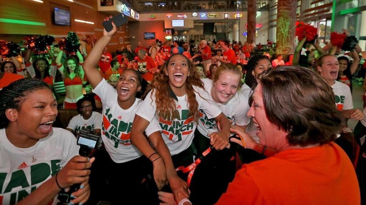 UM head coach Katie Meier (right) celebrates with players Keke Harris, Michelle Woods, Erykah Davenport and Emese Hof at the University of Miami Rathskeller on Monday, March 14, 2016.