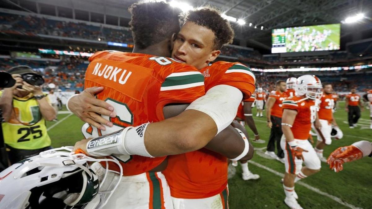 Miami Hurricanes tight end David Njoku (86) hugs quarterback Brad Kaaya (15) after the University of Miami defeats Duke at Hard Rock Stadium in Miami Gardens on Sat., Nov. 26, 2016. The Hurricanes’ career passing record-holder and his talented tight end say they want to focus on preparing for West Virginia in the Russell Athletic Bowl.