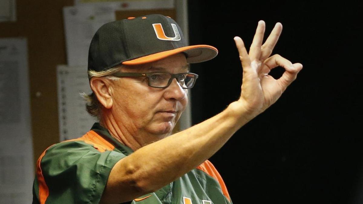 
Miami head coach Jim Morris signals as the University of Miami hosts Florida International University in the NCAA Baseball Championship Coral Gables Regional at Mark Light Field in Coral Gables on Friday, May 29, 2015.
