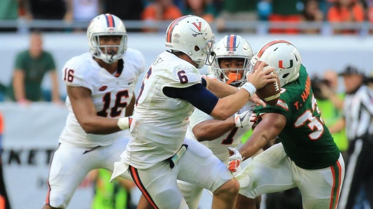 Miami Hurricanes defensive end Trent Harris sacks Virginia Cavaliers quarterback Kurt Benkert in the fourth quarter at Hard Rock Stadium on Saturday, November 18, 2017.