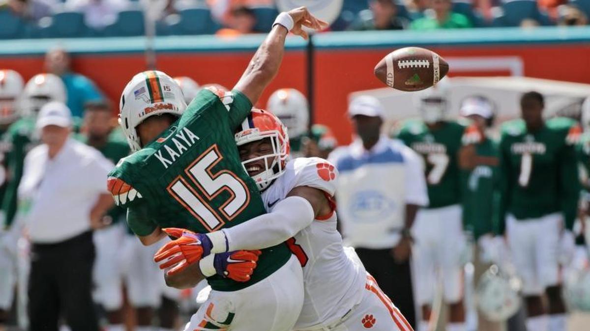 Clemson defensive end Kevin Dodd tackles University of Miami quarterback Brad Kaaya (15) as he passes during the first half of their NCAA college football game on Saturday, Oct. 24, 2015, in Miami Gardens. Clemson won the game 58-0.