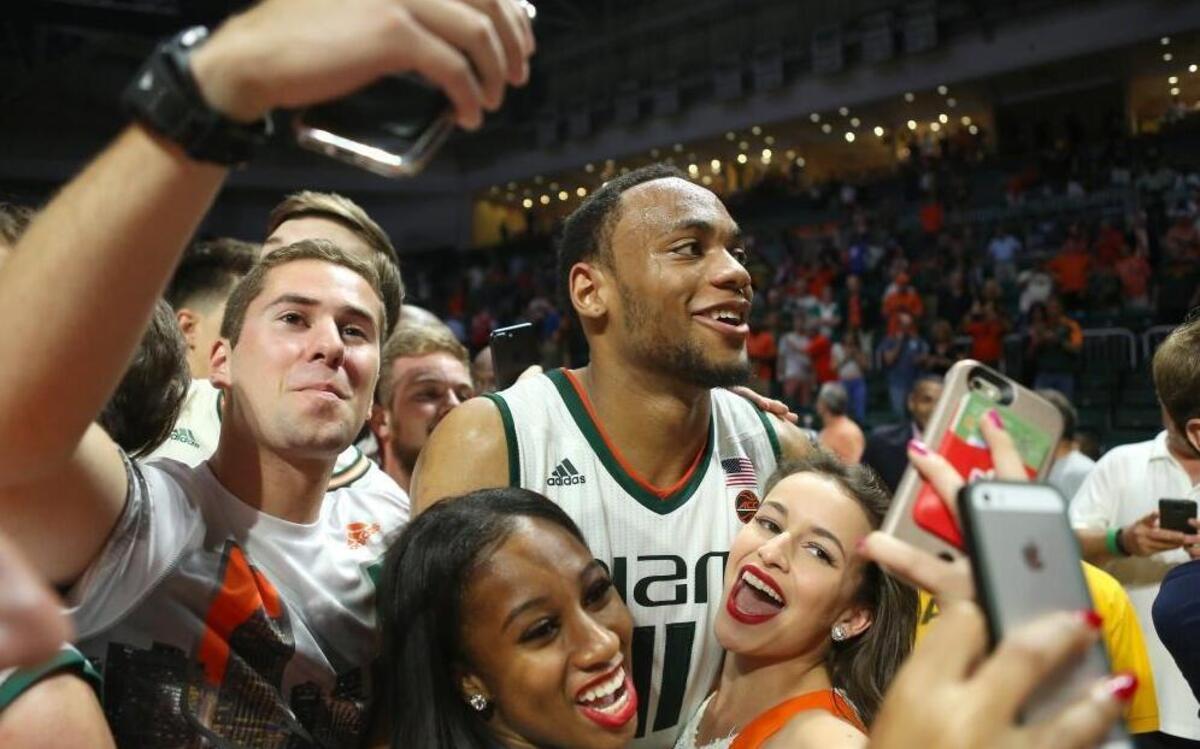 Miami Hurricanes guard Bruce Brown celebrate celebrate with fans after defeating the Duke Blue Devils 55-50 during an NCAA college basketball game at the Watsco Center in Coral Gables on Sat., Feb. 25, 2017.