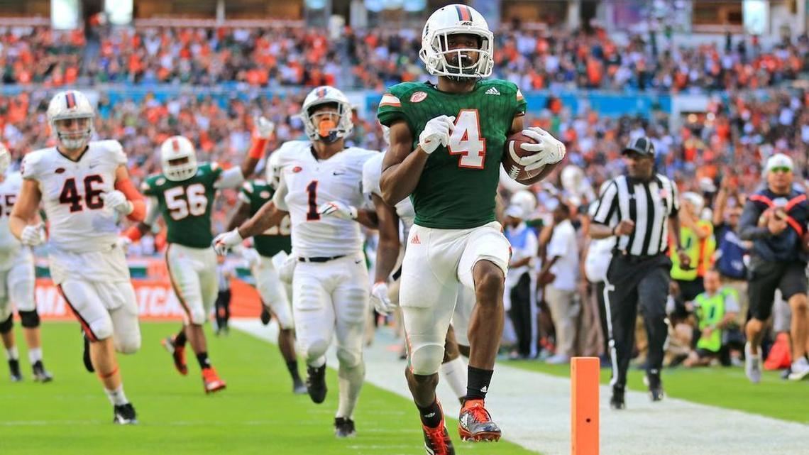 Miami Hurricanes safety Jaquan Johnson returns an interception for a third-quarter touchdown against Virginia at Hard Rock Stadium on Saturday, Nov. 18, 2017. Johnson, coming off a great season, again stands to be the leader of UM's secondary.