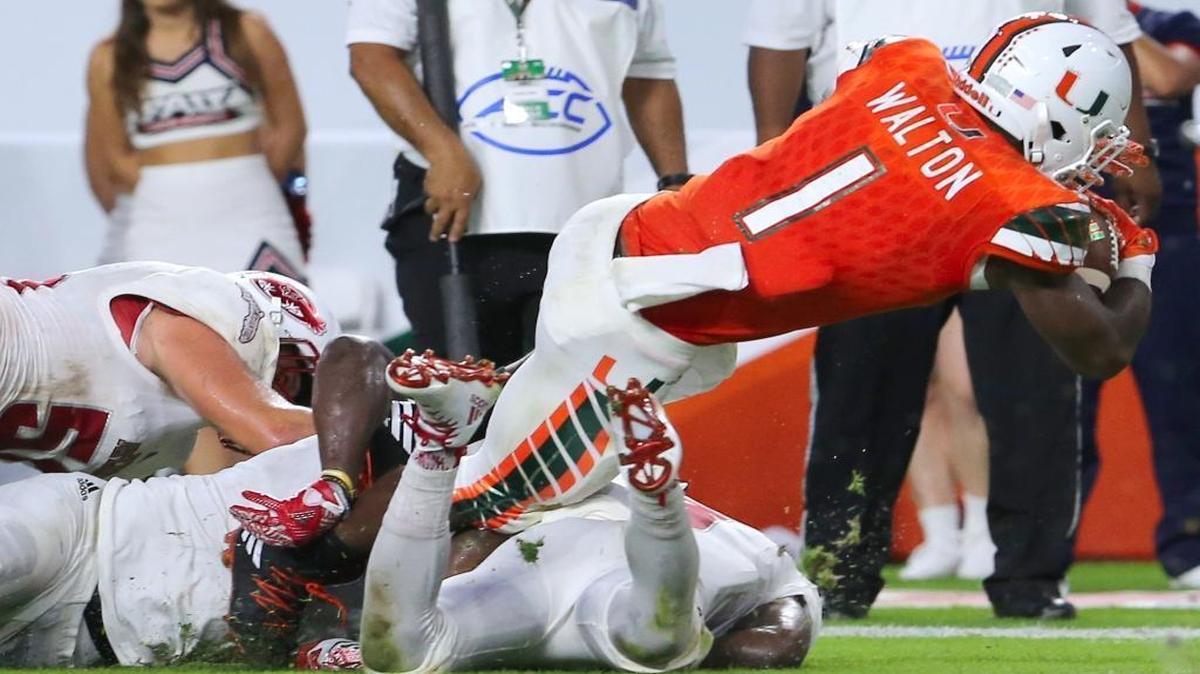University of Miami Hurricanes running back Mark Walton runs for a touchdown against the FAU Owls in the second quarter of an NCAA college football game on Saturday Sept. 10, 2016, at Hard Rock Stadium in Miami Gardens.