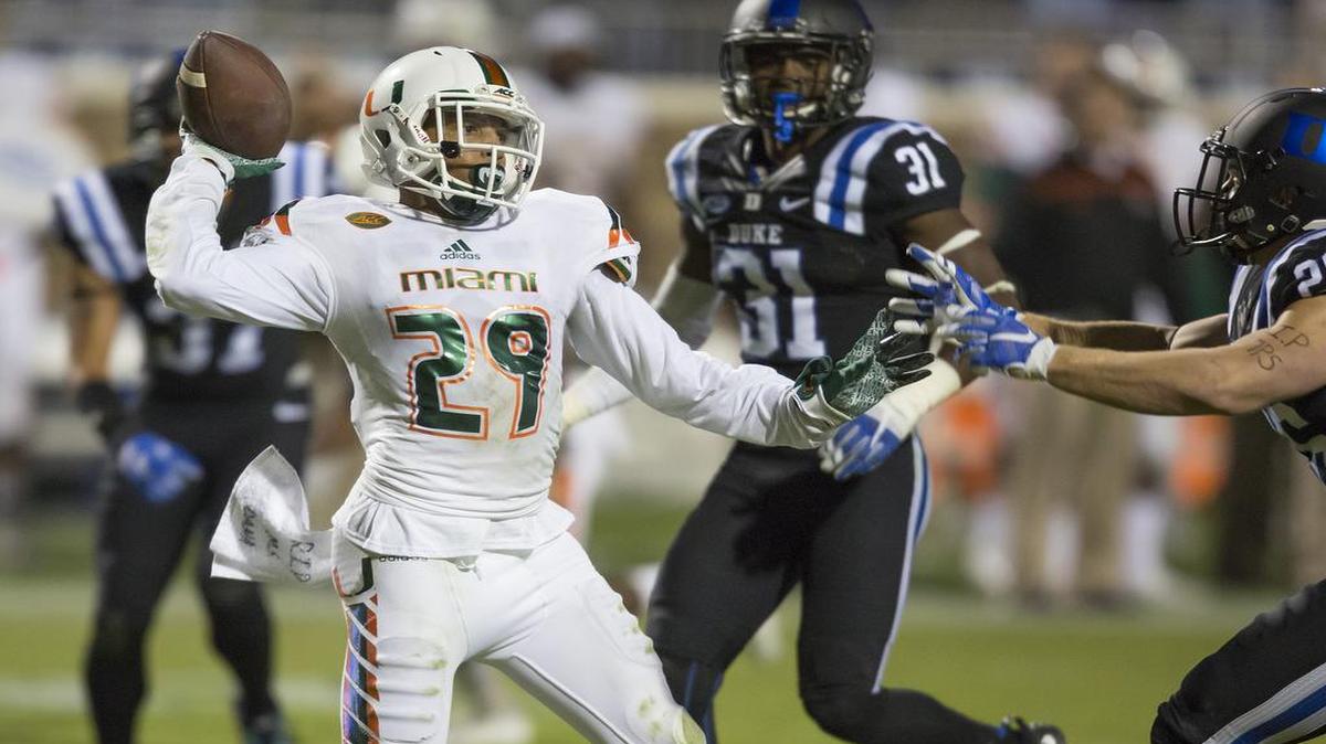 Miami's Corn Elder throws a lateral during a kickoff return which featured multiple laterals before Elder subsequently received the final lateral and scored to beat Duke 30-27 in an NCAA college football game, in Durham, N.C., Saturday, Oct. 31, 2015.