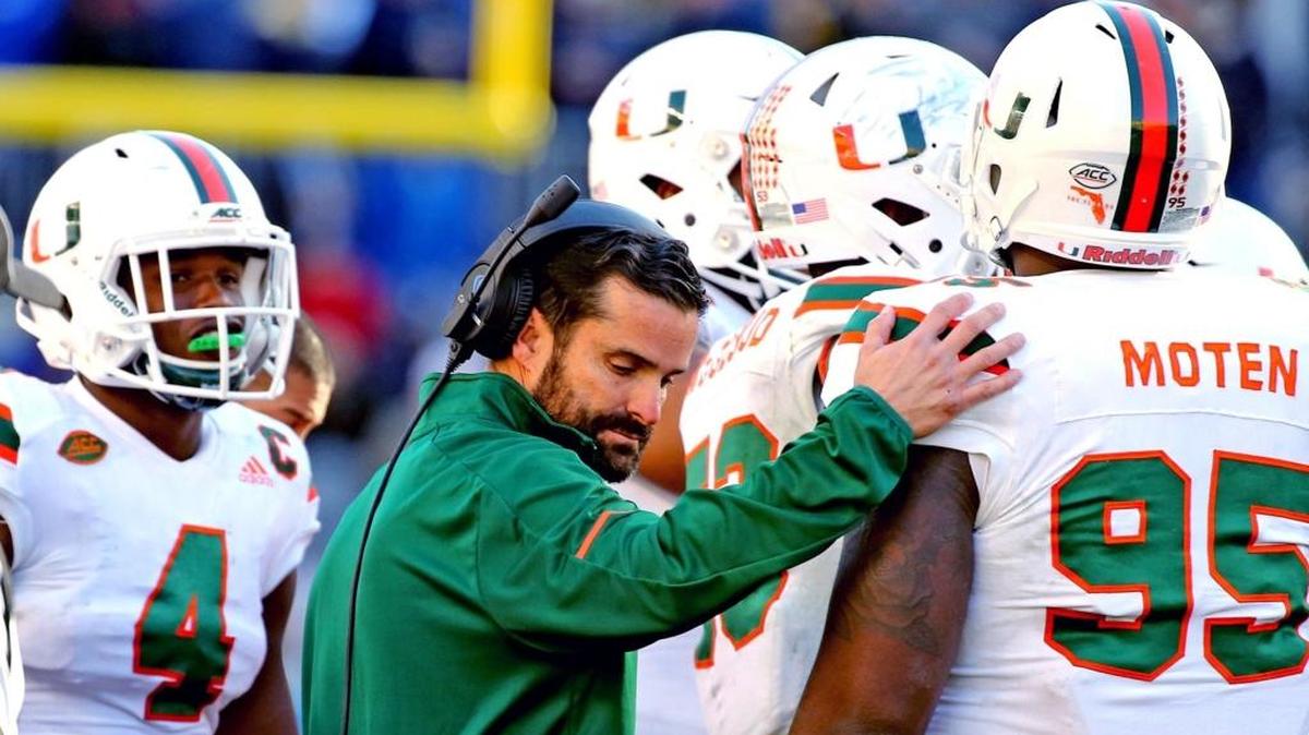 Miami Hurricanes defensive coordinator Manny Diaz consoles his players near the end of the fourth quarter of UM’s 24-14 loss at Pittsburgh on Friday, Nov. 24, 2017.