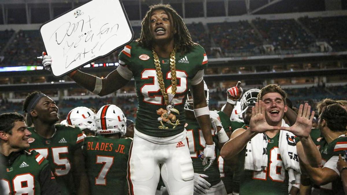 Miami Hurricanes defensive back Sheldrick Redwine (22) celebrates on the bench after intercepting the ball in the third quarter against Savannah State at Hard Rock Stadium in Miami Gardens on Saturday, Sept. 8, 2018.