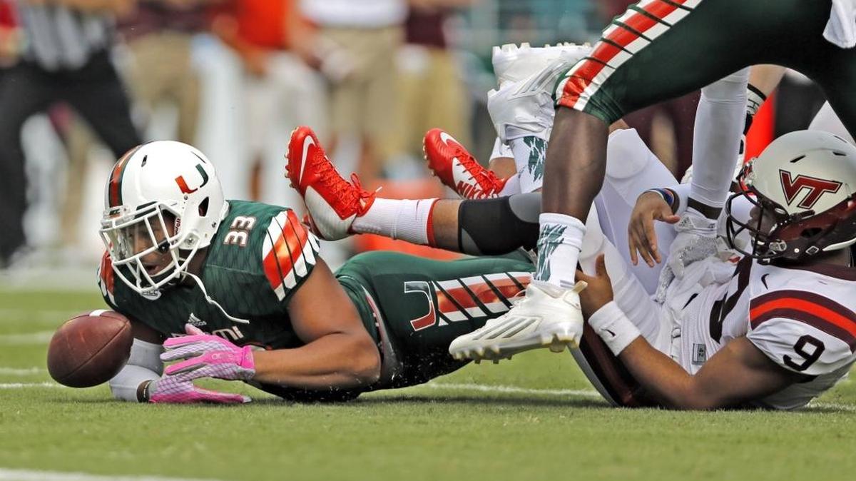 UM defensive lineman Trent Harris (33) recovers a fumble by Virginia Tech quarterback Brenden Motley in the first quarter at Sun Life Stadium on Saturday, Oct. 17, 2015.