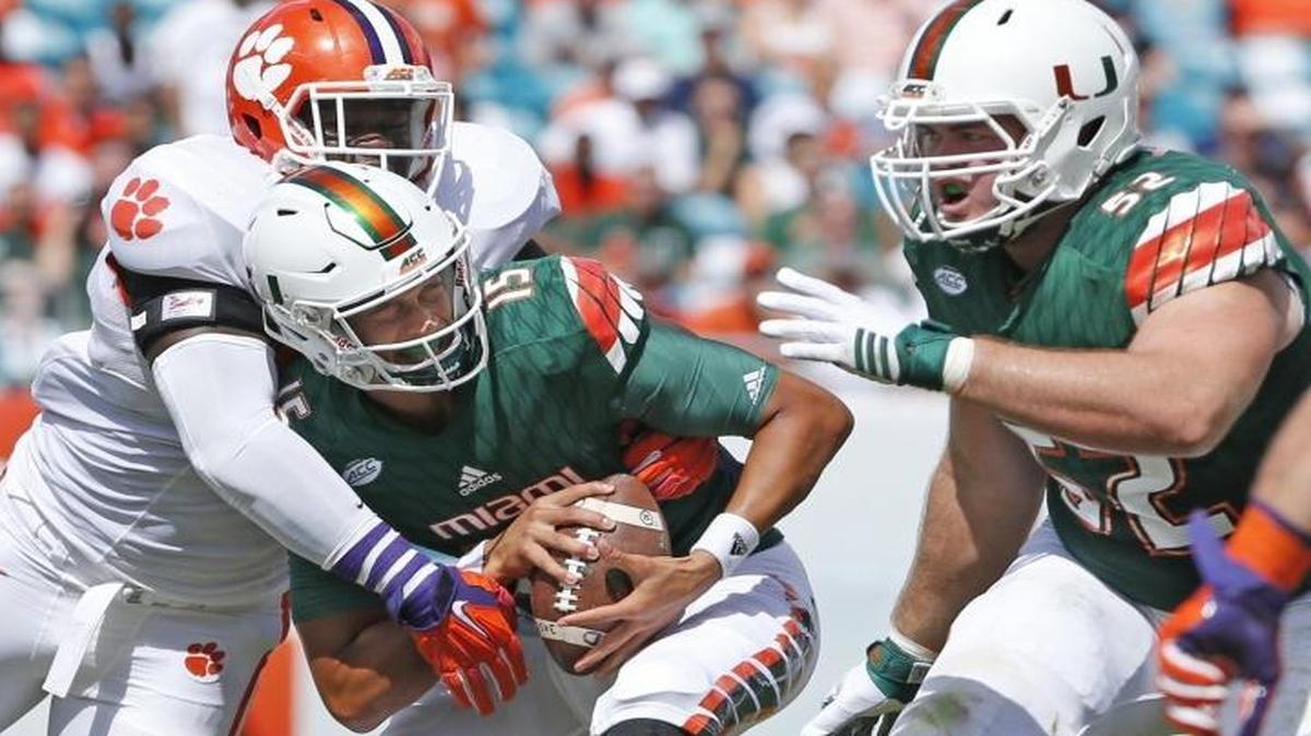 Miami's Brad Kaaya is sacked by Clemson's Shaq Lawson in the first quarter as the University of Miami hosts Clemson at Sun Life Stadium on Saturday, October 24, 2015.