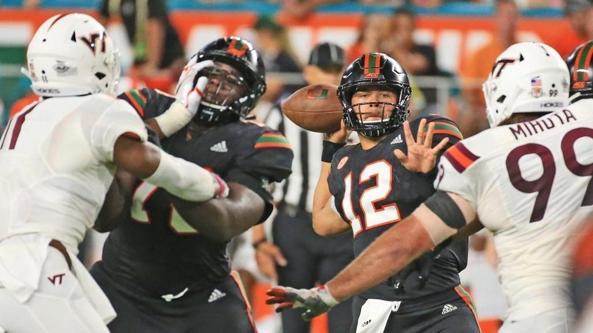 Miami Hurricanes quarterback Malik Rosier is guarded by one of his offensive linemen has he sets up to pass against Virginia Tech at Hard Rock Stadium on Saturday, November 4, 2017.