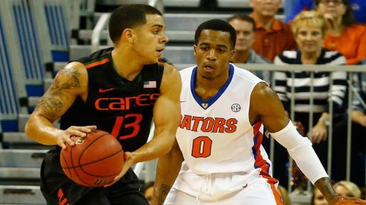 
Angel Rodriguez #13 of the Miami (Fl) Hurricanes is gaurded by Kasey Hill #0 of the Florida Gators during the game at Stephen C. O'Connell Center on November 17, 2014 in Gainesville, Florida. 
