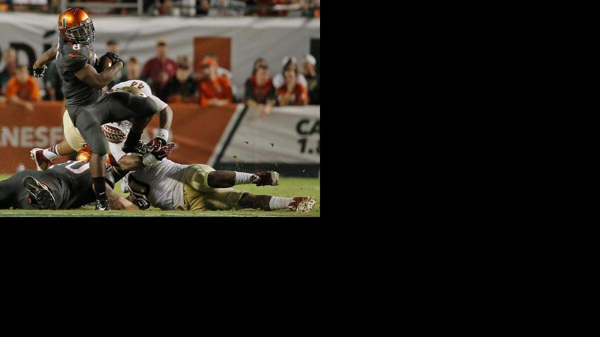 
Personal victory in losing cause: Duke Johnson gallops through the Seminoles defense during Saturday night’s game. Johnson had 130 yards on 27 carries and a touchdown, a year after breaking his ankle against Florida St.
