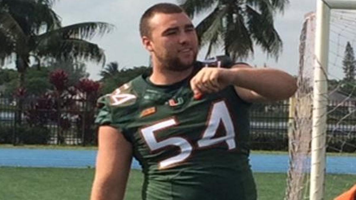 
UM offensive lineman Hunter Knighton throws a pass to a youth football player during a community outreach event at Betty T. Ferguson Park in Miami Gardens on Thursday, June 11, 2015. 
