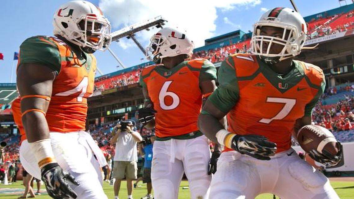 
Miami Hurricanes running back Gus Edwards (7) scores in the fourth quarter as the University of Miami hosts Cincinnati at Sun Life Stadium on Saturday, October 11, 2014.
