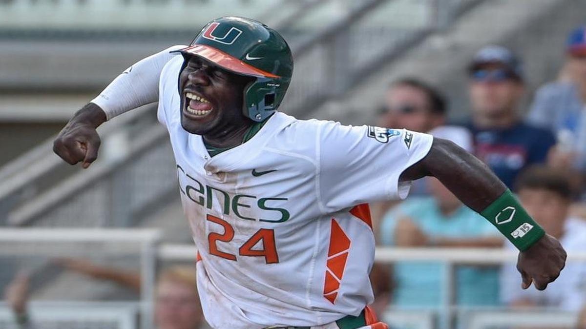 
Miami's Jacob Heyward (24) celebrates a go-ahead run after a series of throwing errors by Arkansas, in the seventh inning of an NCAA College World Series baseball elimination game at TD Ameritrade Park in Omaha, Neb., Monday, June 15, 2015. 

