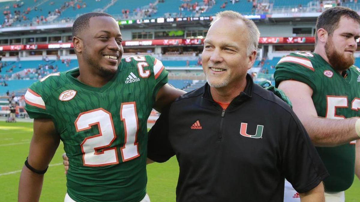 Miami Hurricanes coach Mark Richt shares a happy moment with receiver Malik Mayweather after the University of Miami defeated the Virginia Cavaliers at Hard Rock Stadium on Saturday, Nov. 18, 2017.