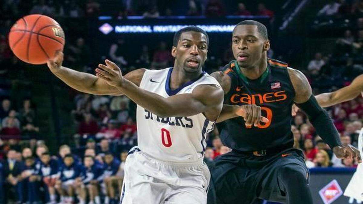 
Richmond guard Kendall Anthony, left, throws a pass as Miami guard Sheldon McClellan, right, plays defense during the first half of an NIT game in Richmond, Va., on Tuesday, March 24, 2015.
