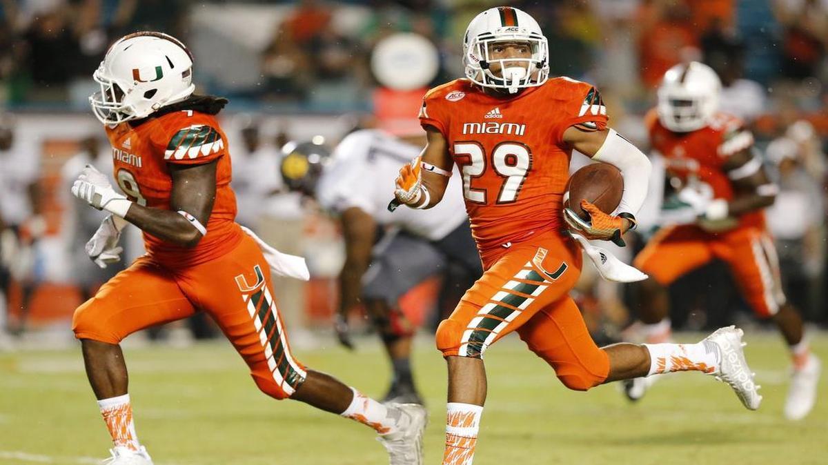 
Miami Hurricanes defensive back Corn Elder (29) scores on a punt return late in the second quarter as the University of Miami hosts Bethune Cookman at Sun Life Stadium on Saturday, September 5, 2015.
