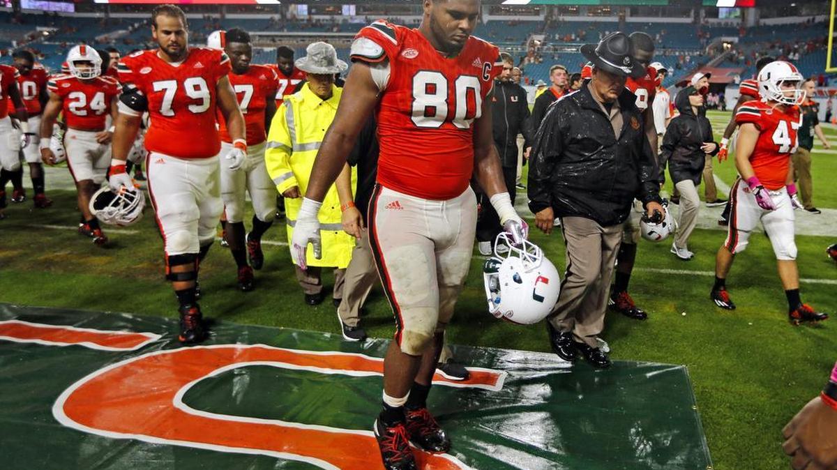 Miami Hurricanes defensive lineman RJ McIntosh (80) and teammates walks off the field after loss to the University of North Carolina Tar Heels at Hard Rock Stadium on Saturday, October 15, 2016.