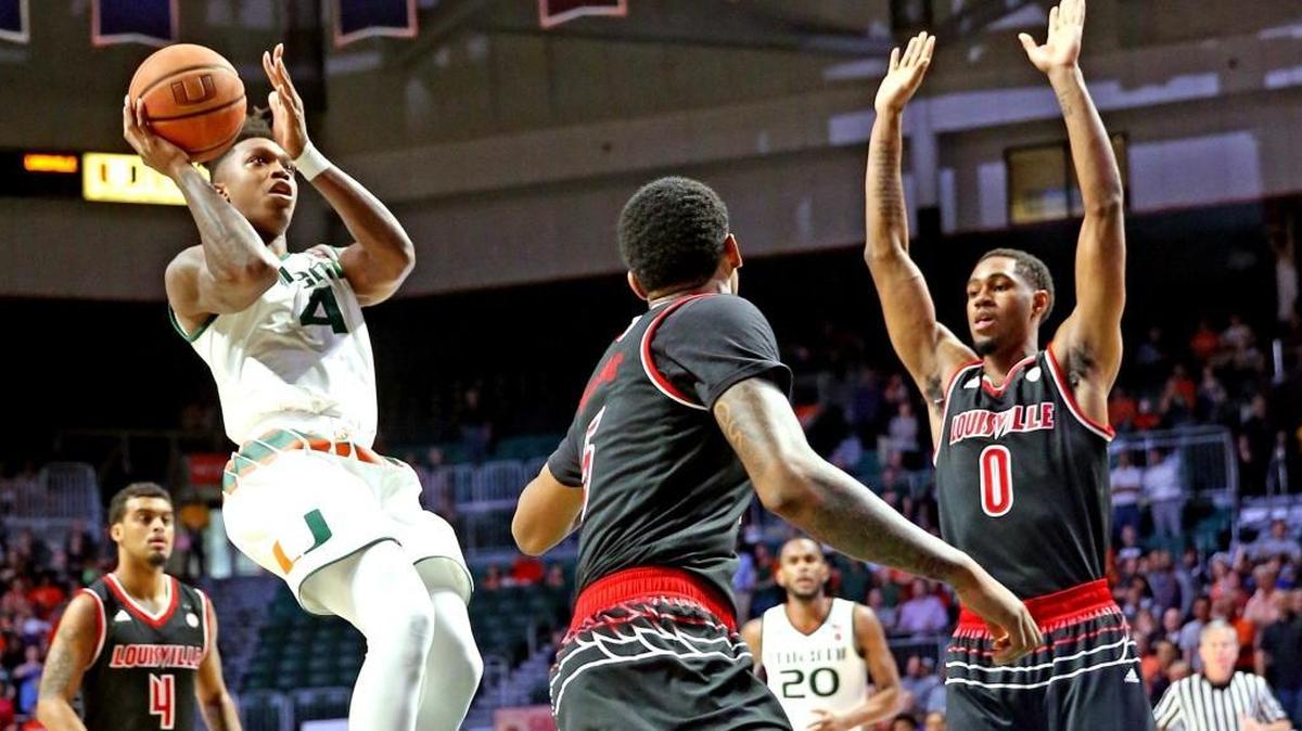Miami Hurricanes Lonnie Walker IV leaps to shoot a basket as they play the Louisville Cardinals in the first period at the WATSCO Center in Coral Gables, January 24, 2018.