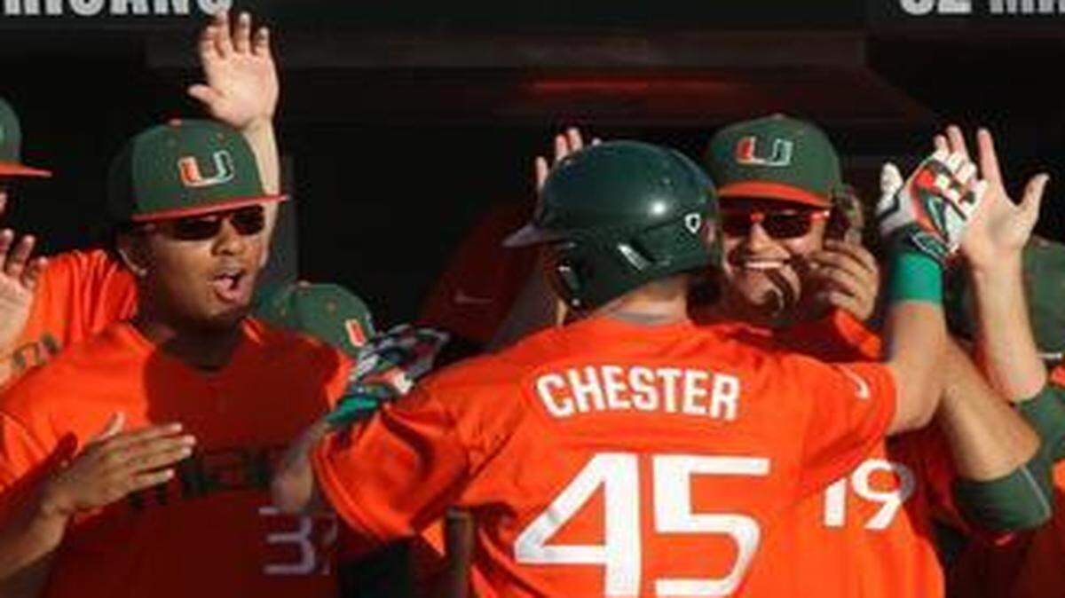 
Carl Chester gets high fives from teammates after hitting a home run for UM against Stetson on Wednesday, March 11, 2015 at Mark Light Field.
