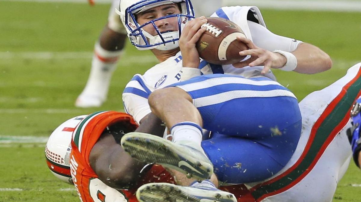 Duke quarterback Daniel Jones, top, is sacked by Miami defensive end Joe Jackson in a 2016 game. Jones looms as a potential first-round options for the Dolphins.