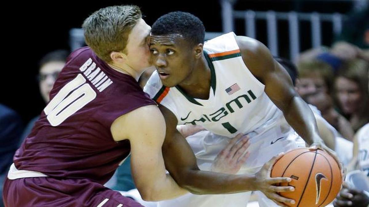 
College of Charleston guard Pat Branin (10) attempts to steal the ball from Miami guard Deandre Burnett (1) during the second half of an NCAA college basketball game, Tuesday, Dec. 30, 2014, in Coral Gables, Fla. 
