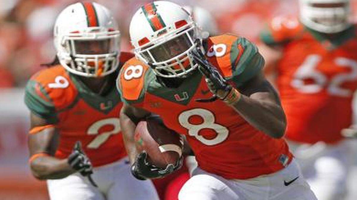 
Miami Hurricanes running back Duke Johnson (8) on a 27-yard carry in the third quarter as the University of Miami hosts Cincinnati at Sun Life Stadium on Saturday, October 11, 2014.
