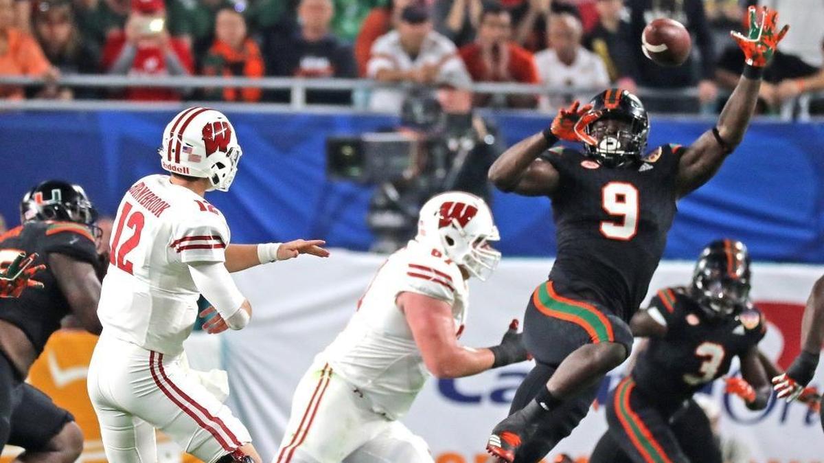 Miami Hurricanes Chad Thomas (9) tries to block Wisconsin Badgers quarterback Alex Hornibrook's pass in the 2017 Capital One Orange Bowl at Hard Rock Stadium in Miami Gardens on Dec. 30, 2017. Thomas is projected as a potential third- or fourth-round pick in the 2018 NFL Draft.