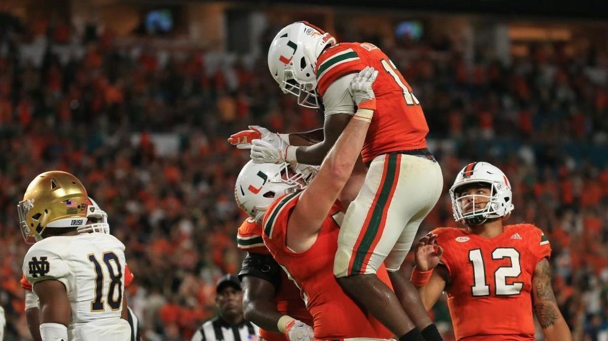 Miami Hurricanes wide receiver DeeJay Dallas celebrates his touchdown with offensive lineman Kc McDermott against Notre Dame at Hard Rock Stadium on Sat., Nov. 11, 2017.