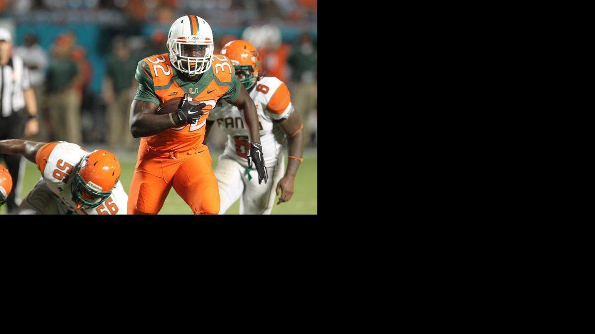 Trayone Gray scampers into the endzone in the fourth quarter as the University of Miami Hurricanes play the Florida A&M Rattlers at Sun Life Stadium in Miami on Saturday, September 6, 2014.

