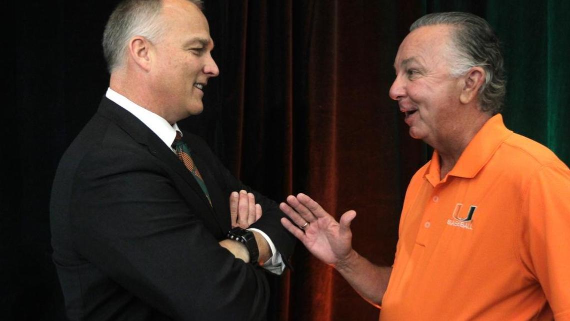 Mark Richt, left, talks to UM baseball coach Jim Morris after being introduced as the new football coach at the University of Miami, Friday, Dec. 4, 2015, in Coral Gables, Fla.