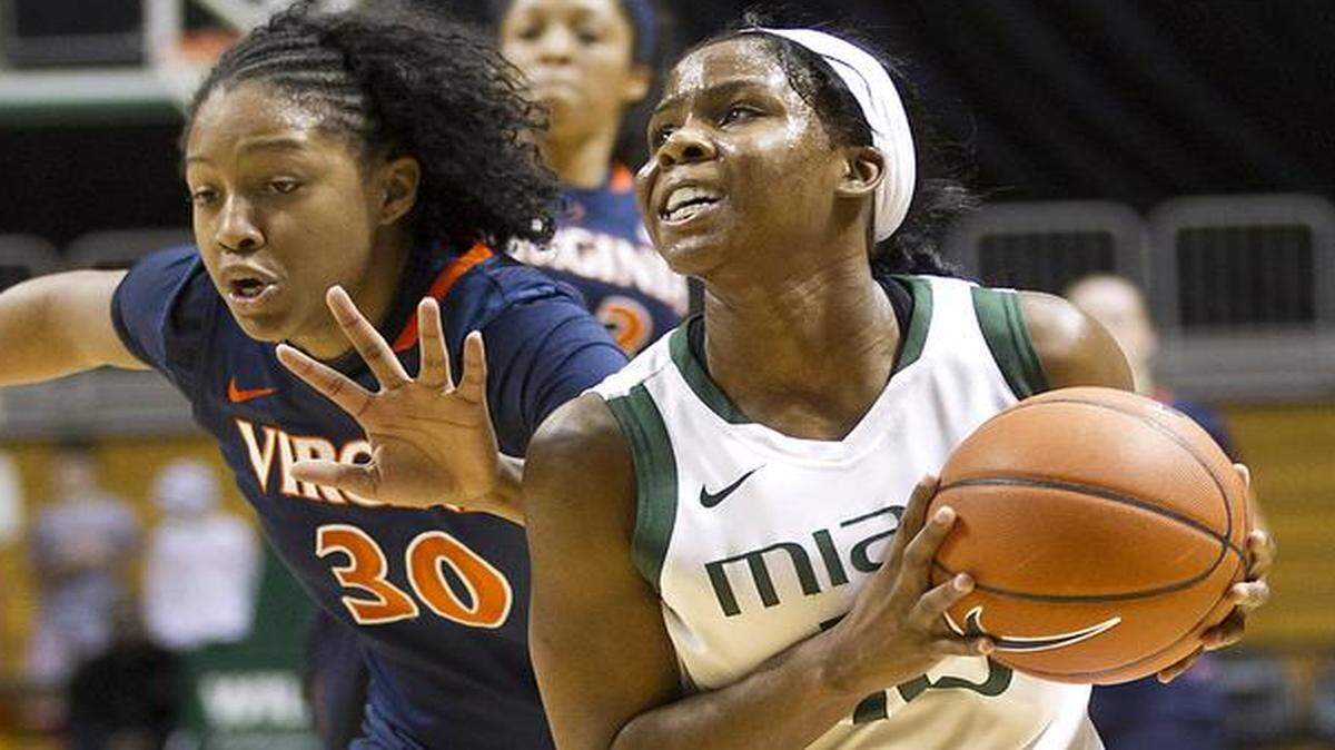 
UM’s Michelle Woods drives to the hoop against Telia McCall of Virginia at BankUnited Center on Jan. 6, 2013. 
