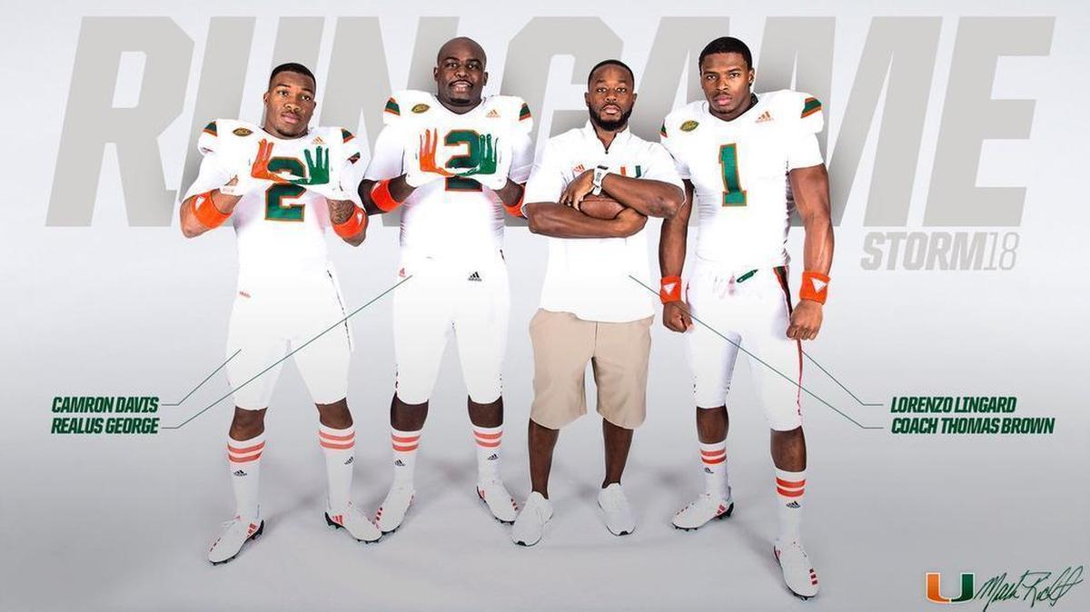 From left: Cam’Ron Davis, Realus George, UM offensive coordinator/running backs coach Thomas Brown and Lorenzo Lingard.