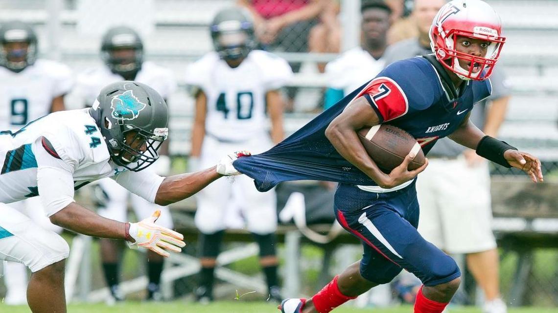 West Port's #44 Tavares Marks shirt tackles Vanguard's #7 N'Kosi Perry in the first quarter on Sept. 3, 2016.