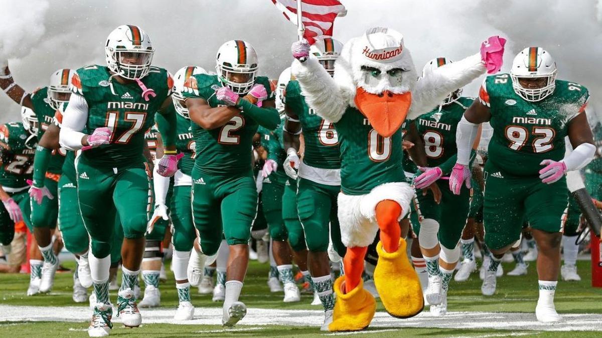 The Hurricanes run onto the field as the University of Miami hosts Virginia Tech at Sun Life Stadium on Saturday, October 17, 2015.