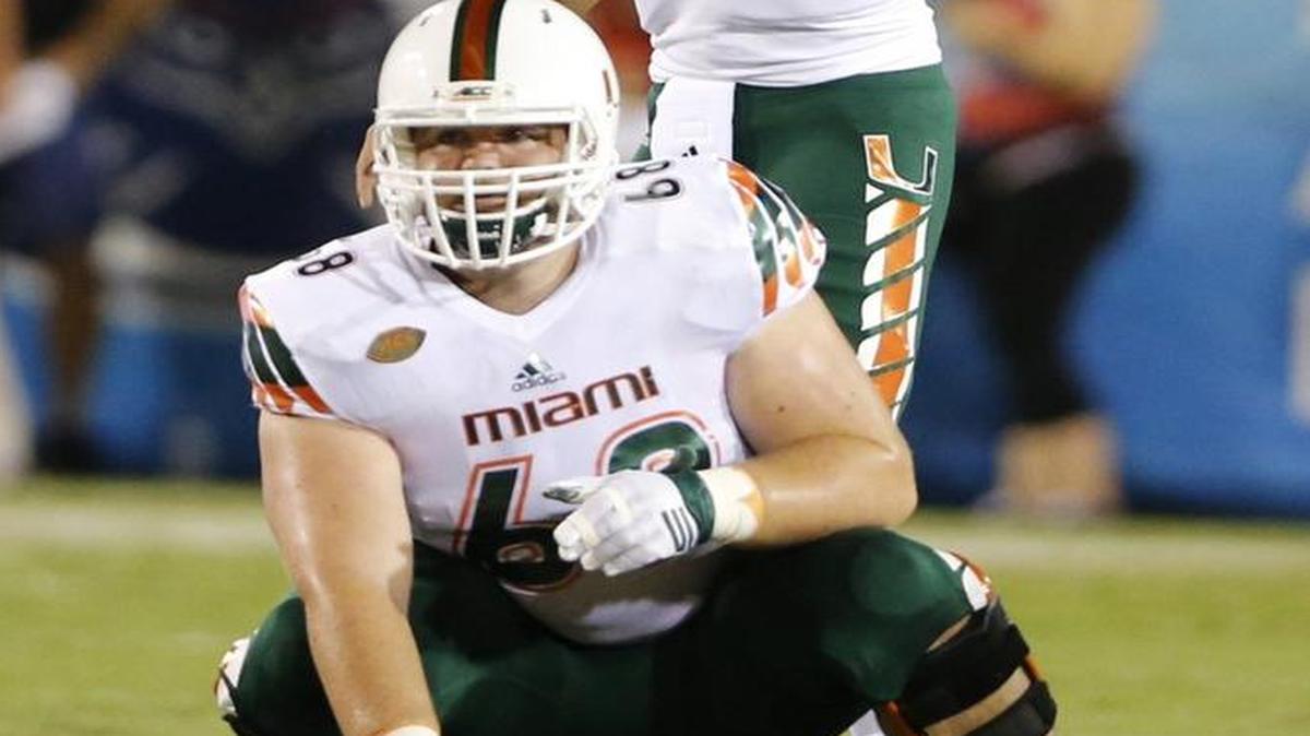 UM quarterback Brad Kaaya prepares to take the snap from center Nick Linder against Florida Atlantic at FAU Stadium in Boca Raton on Friday, Sept. 11, 2015.