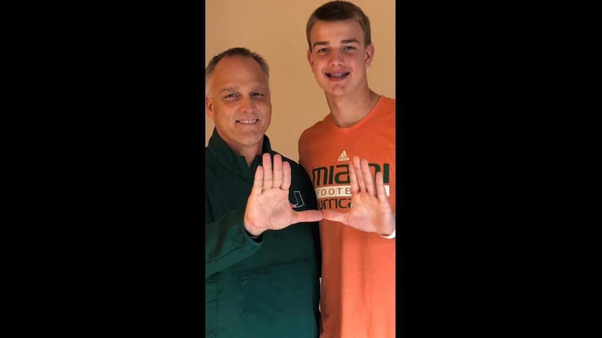 University of Miami football coach Mark Richt throws up the U with his nephew, eighth-grader Jake Johnson. Johnson announced on Twitter that Richt has offered him a scholarship for the Class of 2022.